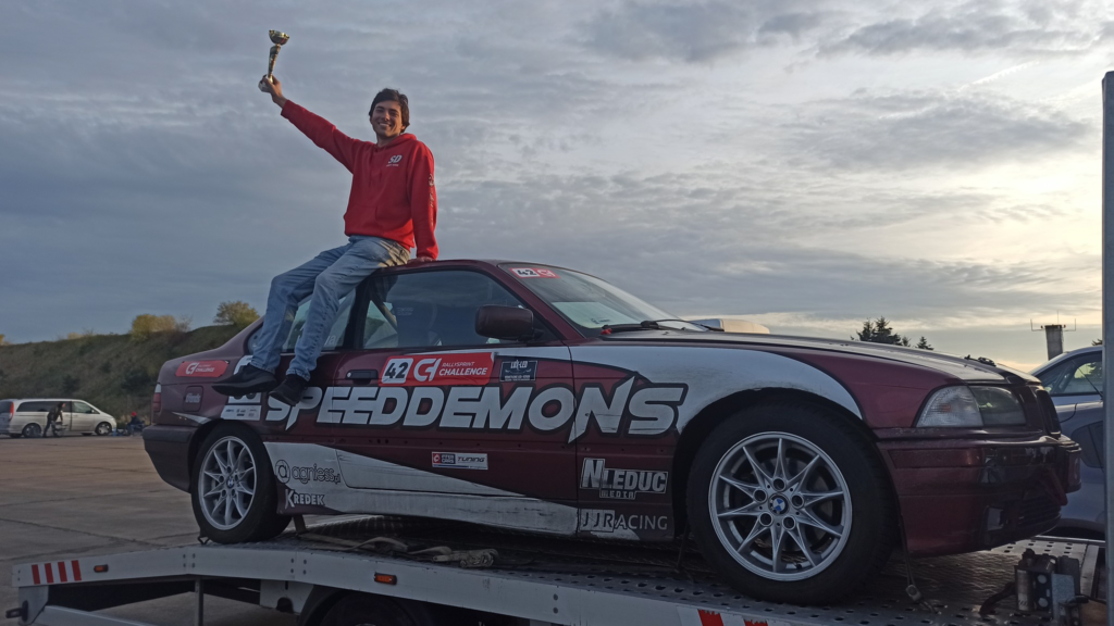 Kacper Antos posing with a cup won in 2022 BMW SPORT class championship. Photo by agniess.pl